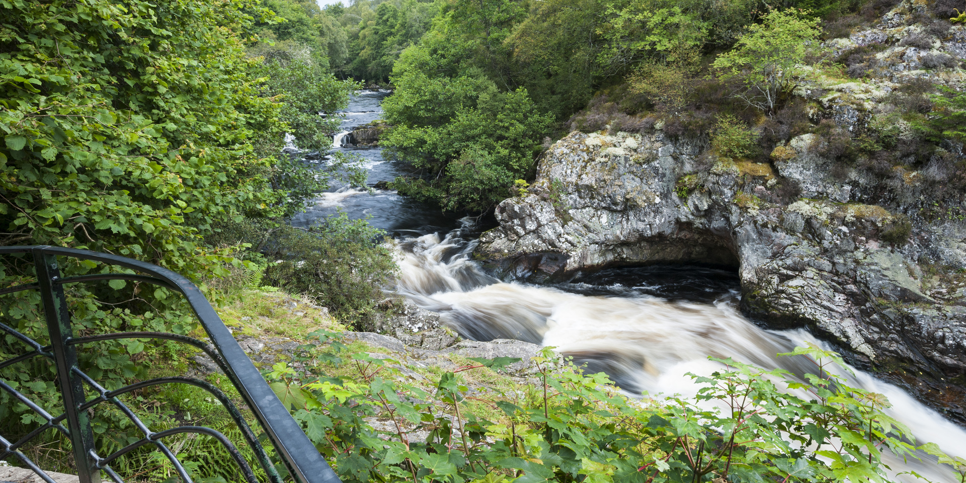 View from viewing platform down onto rapids, waterfall, gorge at Falls of Shin