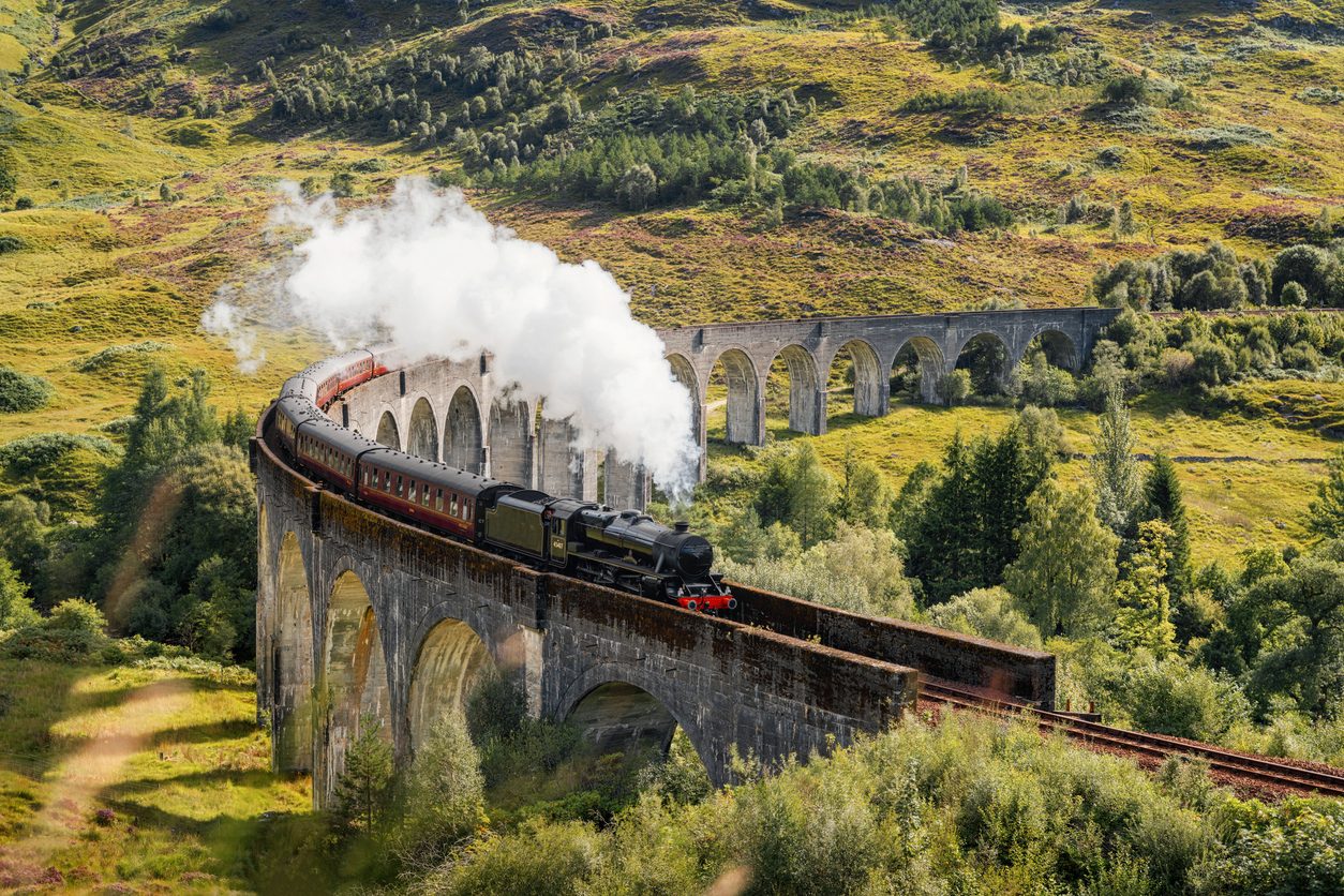 Steam Train on Glenfinnan Viaduct in Scotland Steam Train on Glenfinnan Viaduct in Scotland