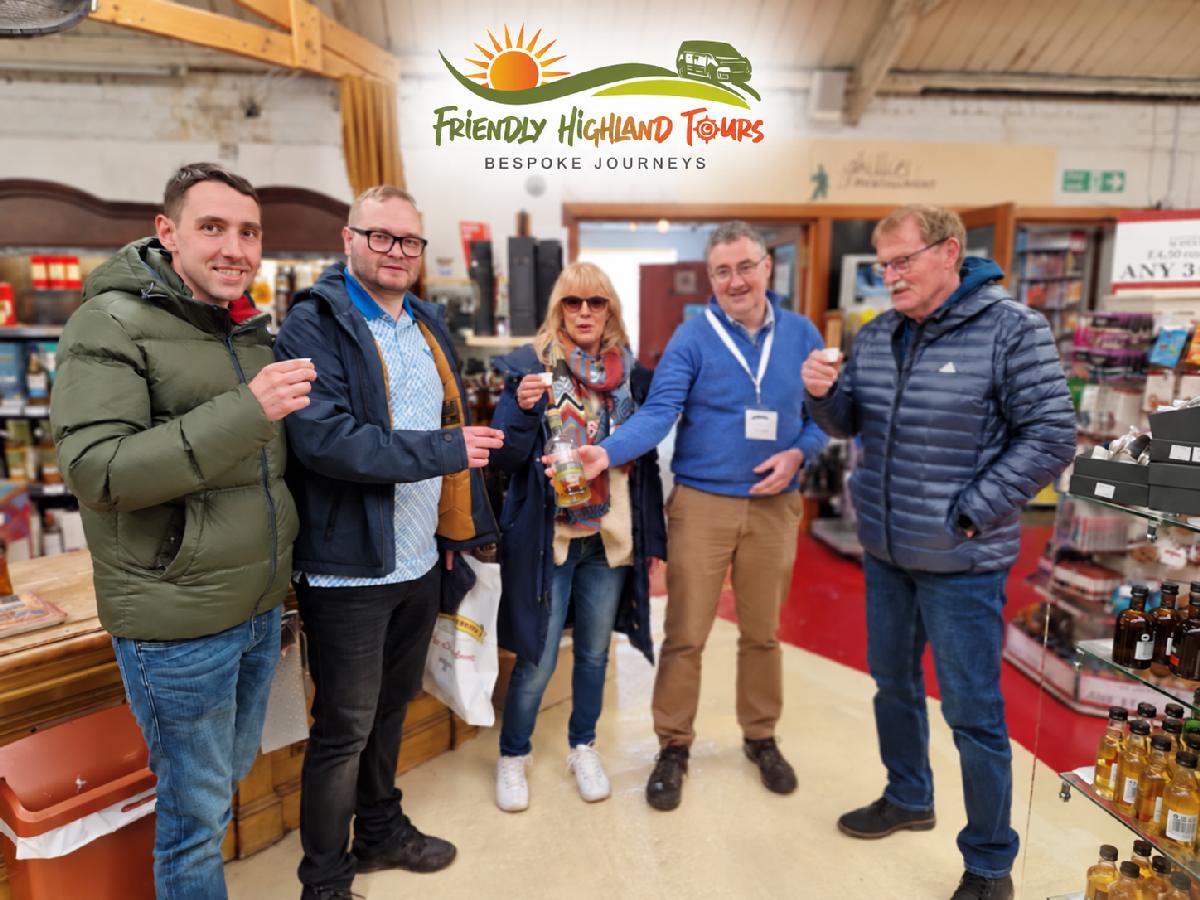 Group of visitors enjoying whisky samples during a Highland distillery visit